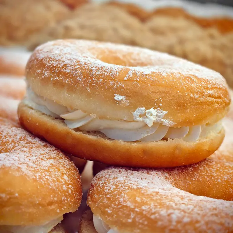 Custard-filled powdered donuts with rich aroma and smooth creamy filling made using premium custard powder for delicious results