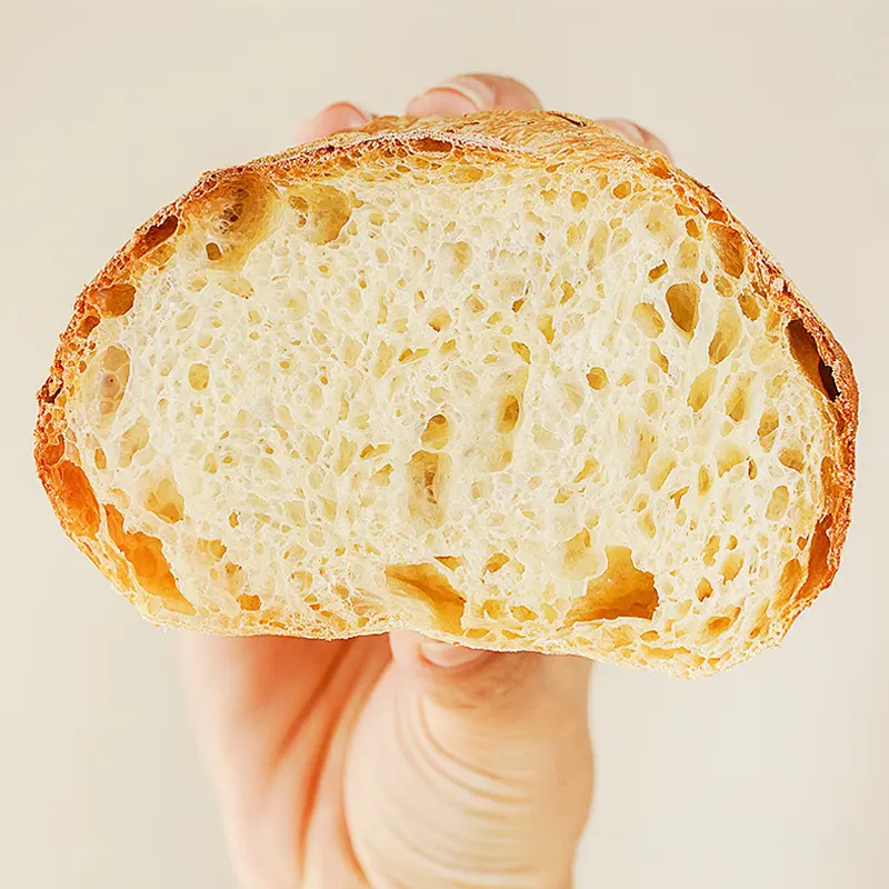 Close-up of artisan bread with airy crumb structure, showing the effect of high-nutrition instant dry yeast enriched with B vitamins and protein.
