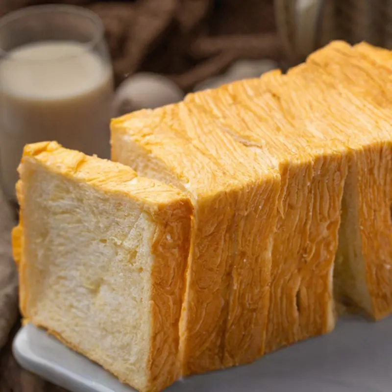 Sliced loaf of soft, golden milk bread made with instant dry yeast, enriched with B vitamins and protein for enhanced nutrition and flavor.