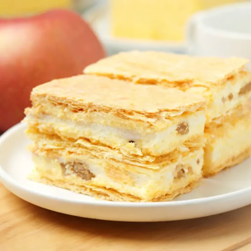 Flaky custard mille-feuille with creamy filling and raisins—perfect custard powder dessert for layered pastries and bakeries
