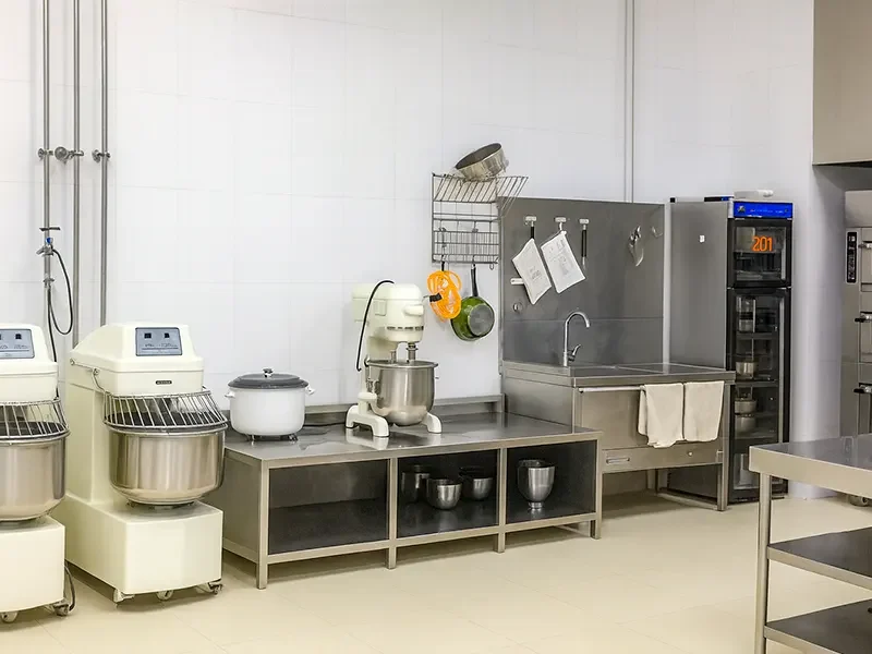 Commercial bakery kitchen with industrial mixers and equipment for efficient custard filling production and streamlined baking workflow
