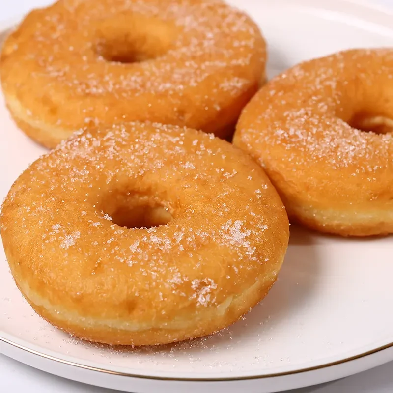 Golden sugar-coated donuts made with high-quality instant dry yeast, offering a soft texture and perfect rise for home or commercial baking.